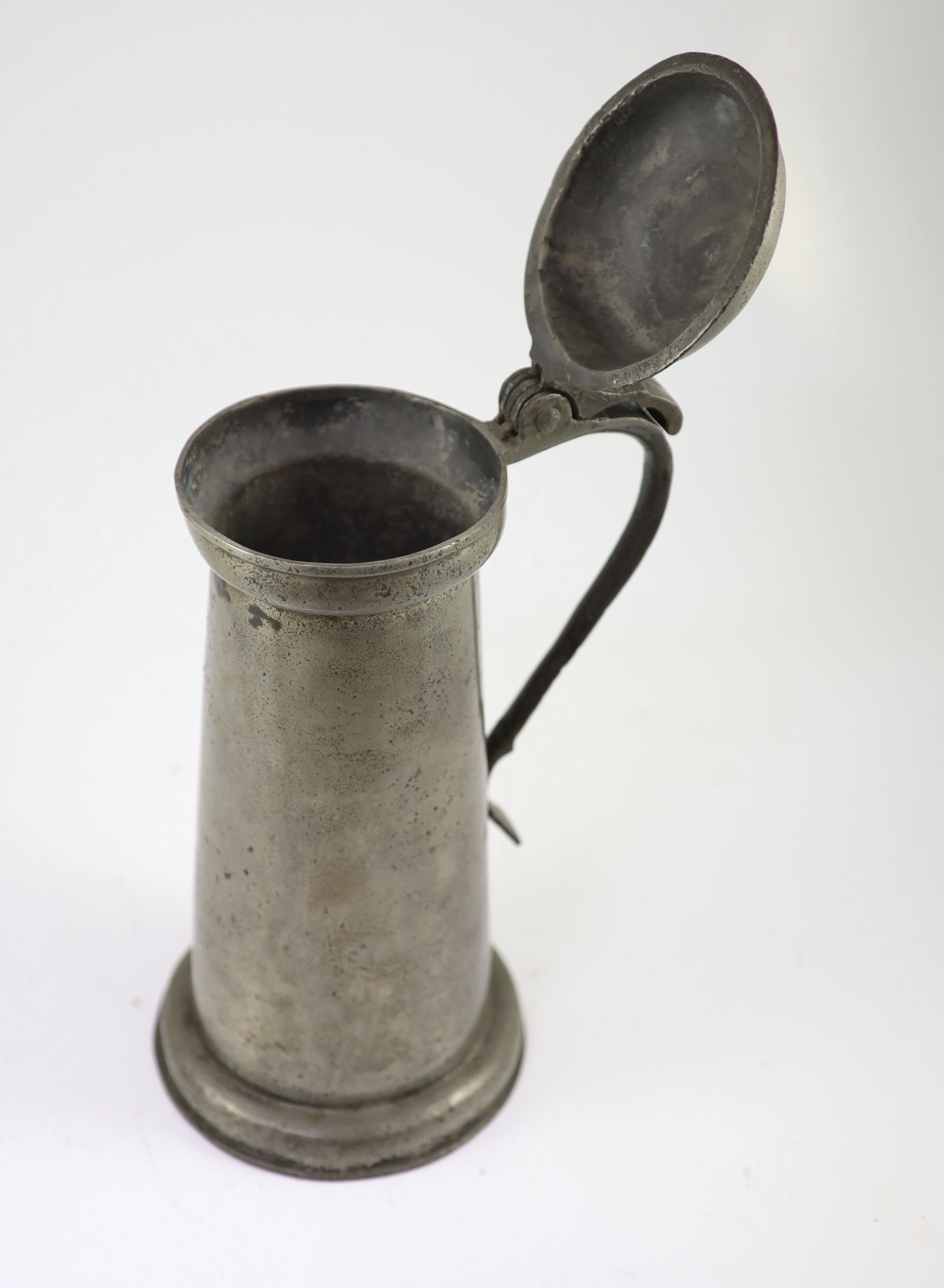 An early 17th century pewter flagon of tall cylindrical form, maker's mark 'BB' H 37cm.